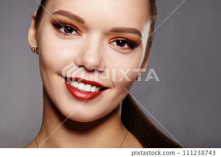 Elegance close-up of female eye with classic dark brown smoky make-up. Macro shot of woman's face part. Beauty, cosmetics and makeup Elegance close-up of female eye with classic dark brown smoky make-up. Macro shot of woman's face part. Beauty, cosmetics and makeup 111238743