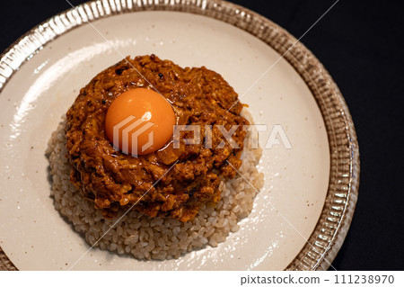 Keema curry topped with egg yolk Keema curry topped with egg yolk 111238970