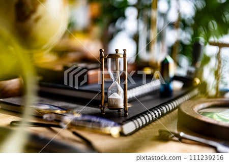 Snap of desk with hourglass 111239216