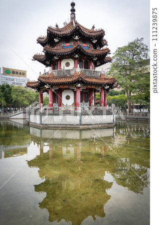 Small Asian temple in city park reflected in a pond, vertical shot, Taipei, Taiwan Small Asian temple in city park reflected in a pond, vertical shot, Taipei, Taiwan 111239875