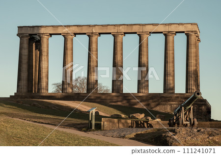 A view of the National Monument of Scotland with a bright blue sky in the background. A view of the National Monument of Scotland with a bright blue sky in the background. 111241071