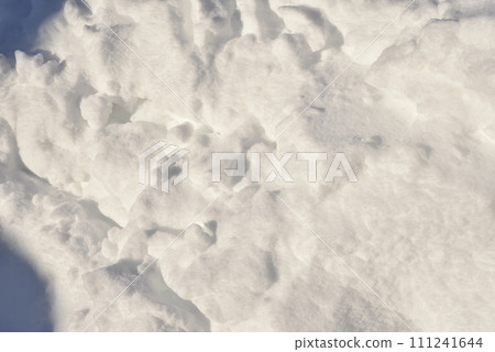 Lumps of snow in winter. Snow and light during the day. Snowdrifts. Lumps of snow in winter. Snow and light during the day. Snowdrifts. 111241644