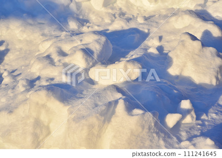 Lumps of snow in winter. Snow and light during the day. Snowdrifts. Lumps of snow in winter. Snow and light during the day. Snowdrifts. 111241645