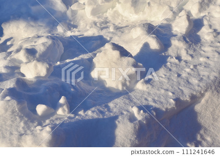 Lumps of snow in winter. Snow and light during the day. Snowdrifts. Lumps of snow in winter. Snow and light during the day. Snowdrifts. 111241646