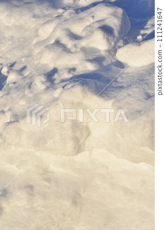 Lumps of snow in winter. Snow and light during the day. Snowdrifts. 111241647