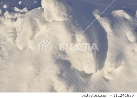 Lumps of snow in winter. Snow and light during the day. Snowdrifts. Lumps of snow in winter. Snow and light during the day. Snowdrifts. 111241650