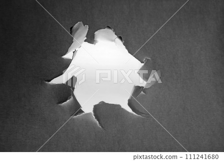 Hole punched in a paper sheet 111241680