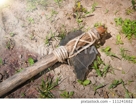 Stone ax of a primitive man Stone ax of a primitive man 111241682