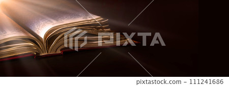 Dark table with open bible 111241686