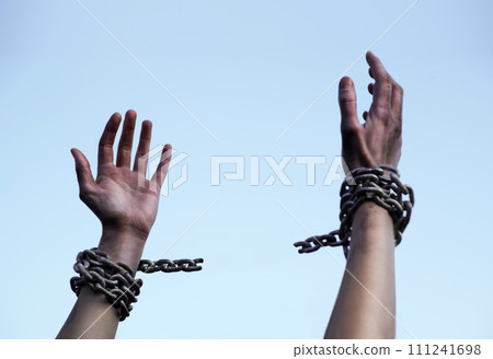 Praying man with shackled hands Praying man with shackled hands 111241698