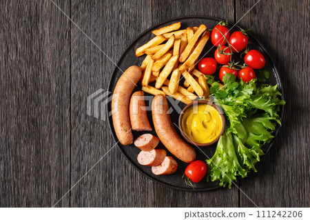 sausages with potato, lettuce, tomatoes, top view 111242206