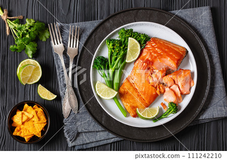hot smoked salmon with cooked broccoli and lime 111242210