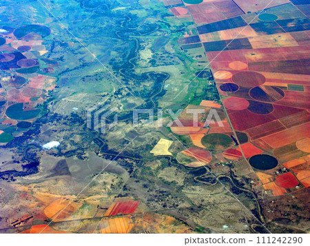 Circular farmland with center pivot irrigation seen from an airplane, United States 111242290