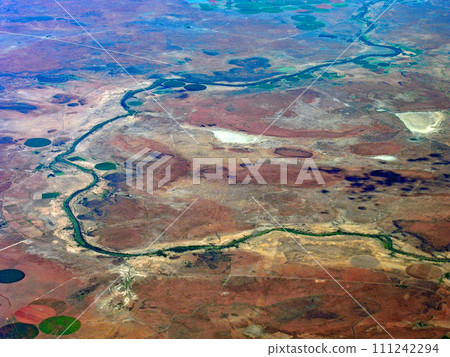 Circular farmland with center pivot irrigation seen from an airplane, United States 111242294