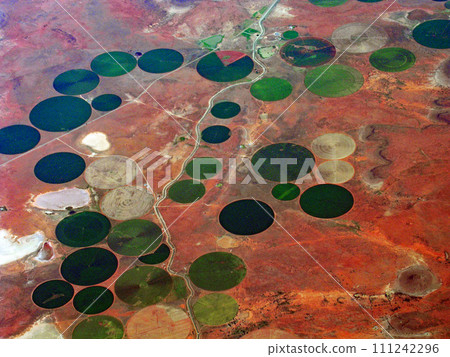 Circular farmland with center pivot irrigation seen from an airplane - South Africa 111242296