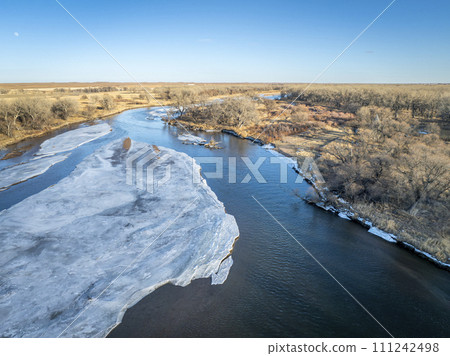 aerial view of the South Platte RIver and plains in eastern Colorado in winter scenery 111242498