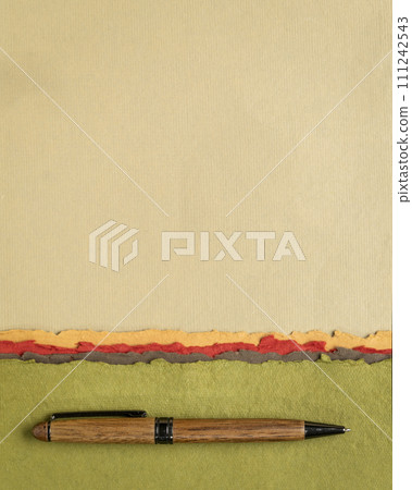 abstract paper landscape in pastel earth tones tones - collection of handmade rag papers with a wooden pen 111242543