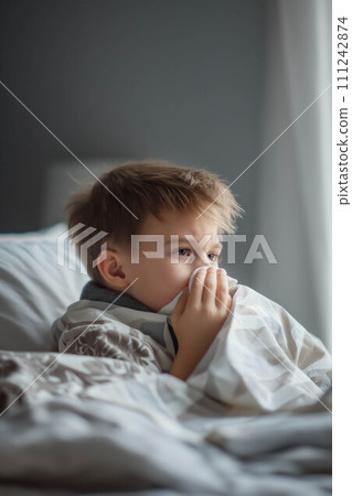 Caucasian boy blows his nose in bed ,The nose doesn't stop running. 111242874