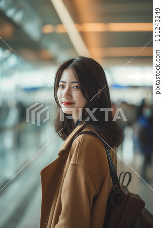 Asian female tourist walking at airport passenger building. Asian female tourist walking at airport passenger building. 111243249