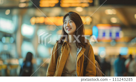 Asian female tourist walking at airport passenger building. 111243285