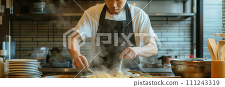 Asian male chef making ramen in the kitchen. 111243319
