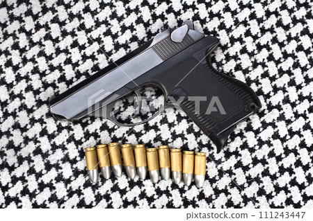 handgun with ammunition on the black and white keffiyeh handgun with ammunition on the black and white keffiyeh 111243447