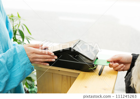 Dog salon, woman paying with credit card Dog salon, woman paying with credit card 111245263