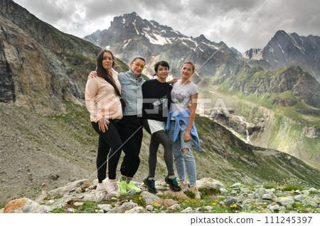 A group of friends climbed high in the mountains 111245397