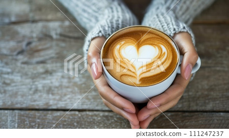AI-generated content. Top view on wood table, Close-up of a woman's hands holding a latte heart. Generative AI 111247237