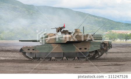 Japan Ground Self-Defense Force Type 10 tank running through smoke 111247526