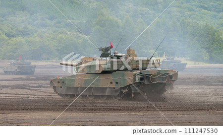 Japan Ground Self-Defense Force Type 10 tank running through smoke 111247530