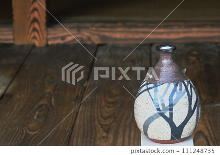 A single flower in the sake bottle of an old folk house A single flower in the sake bottle of an old folk house 111248735
