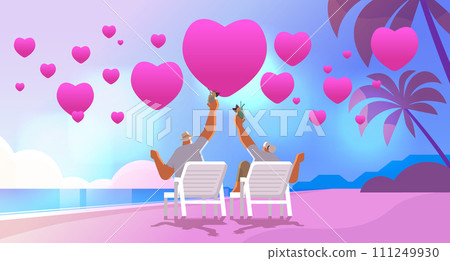 senior man woman drinking cocktails on tropical beach with pink love hearts aged couple celebrating valentines day horizontal 111249930