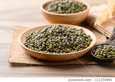 Green mung bean in wooden bowl with spoon, Food ingredients 111250963