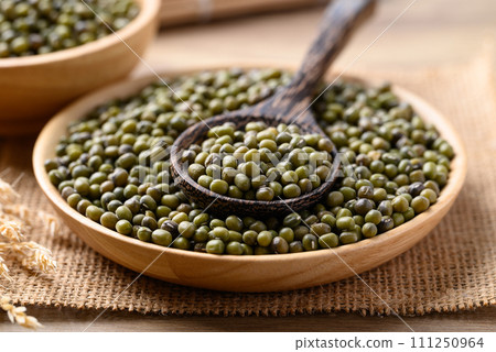 Green mung bean in wooden bowl with spoon, Food ingredients 111250964
