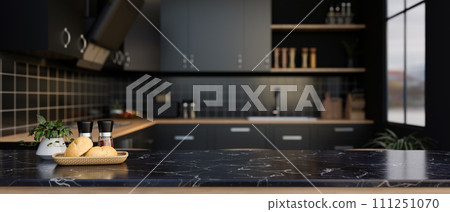 A space for displaying your product on a black marble kitchen countertop in a modern black kitchen. A space for displaying your product on a black marble kitchen countertop in a modern black kitchen. 111251070