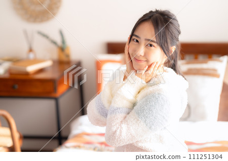 College woman relaxing on bed College woman relaxing on bed 111251304