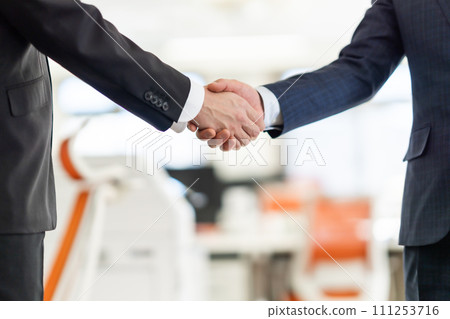 A businessman in a suit shaking hands, without a face A businessman in a suit shaking hands, without a face 111253716