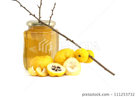 Ripe Japanese quince fruits and honey on white Ripe Japanese quince fruits and honey on white 111253732