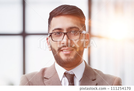 portrait of confident businessman with arms crossed in office 111254170