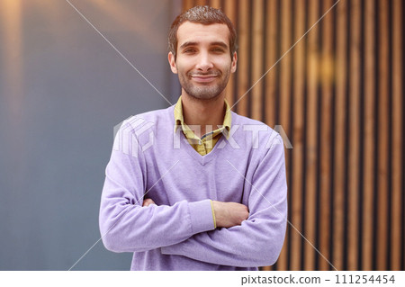 Handsome businessman standing with crossed arms and looking at camera 111254454