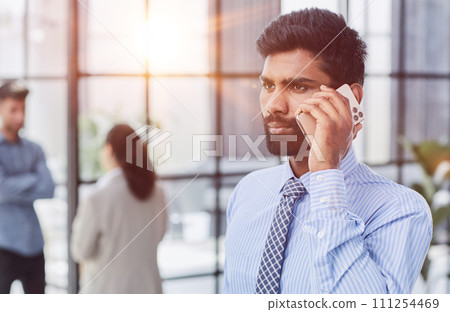 professional businessman executive entrepreneur wearing holding telephone making corporate call on cellphone. professional businessman executive entrepreneur wearing holding telephone making corporate call on cellphone. 111254469