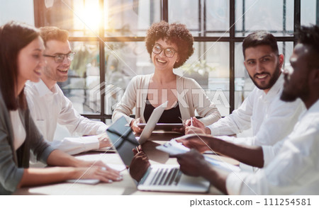 Employees working at computer together, discussing content 111254581