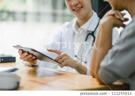 Young male doctor discussing about diagnosis to senior woman patient. Young male doctor discussing about diagnosis to senior woman patient. 111255011