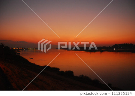 Tropical amazing dramatic golden sky on sunset over scenic river lake seascape ocean. Silhouette tranquil season wilderness serene landscape. Tranquil lake countryside sunrise seaside reflection Tropical amazing dramatic golden sky on sunset over scenic river lake seascape ocean. Silhouette tranquil season wilderness serene landscape. Tranquil lake countryside sunrise seaside reflection 111255134