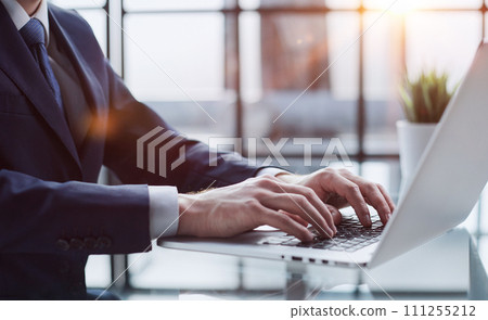 Closeup image of a man working and typing on laptop computer keyboard Closeup image of a man working and typing on laptop computer keyboard 111255212