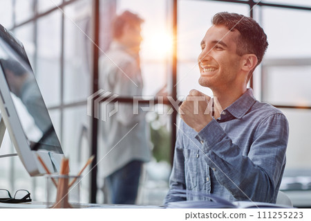 Happy businessman rejoicing success at workplace in office, looking at laptop screen with euphoric expression. 111255223