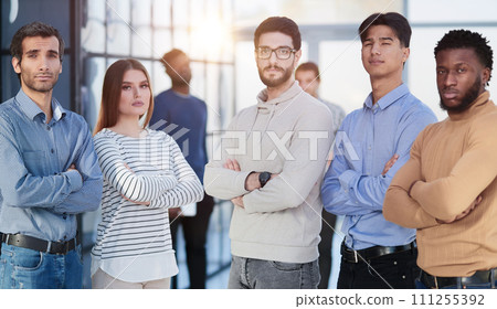 Group of successful businesspeople standing in row and looking at camera at office Group of successful businesspeople standing in row and looking at camera at office 111255392