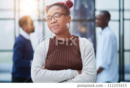 Smiling young woman standing with her arms crossed and looking at camera. Smiling young woman standing with her arms crossed and looking at camera. 111255815