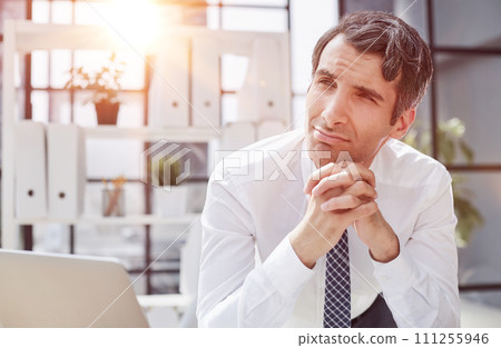 Image of successful businessman 30s thinking and holding index finger at forehead Image of successful businessman 30s thinking and holding index finger at forehead 111255946